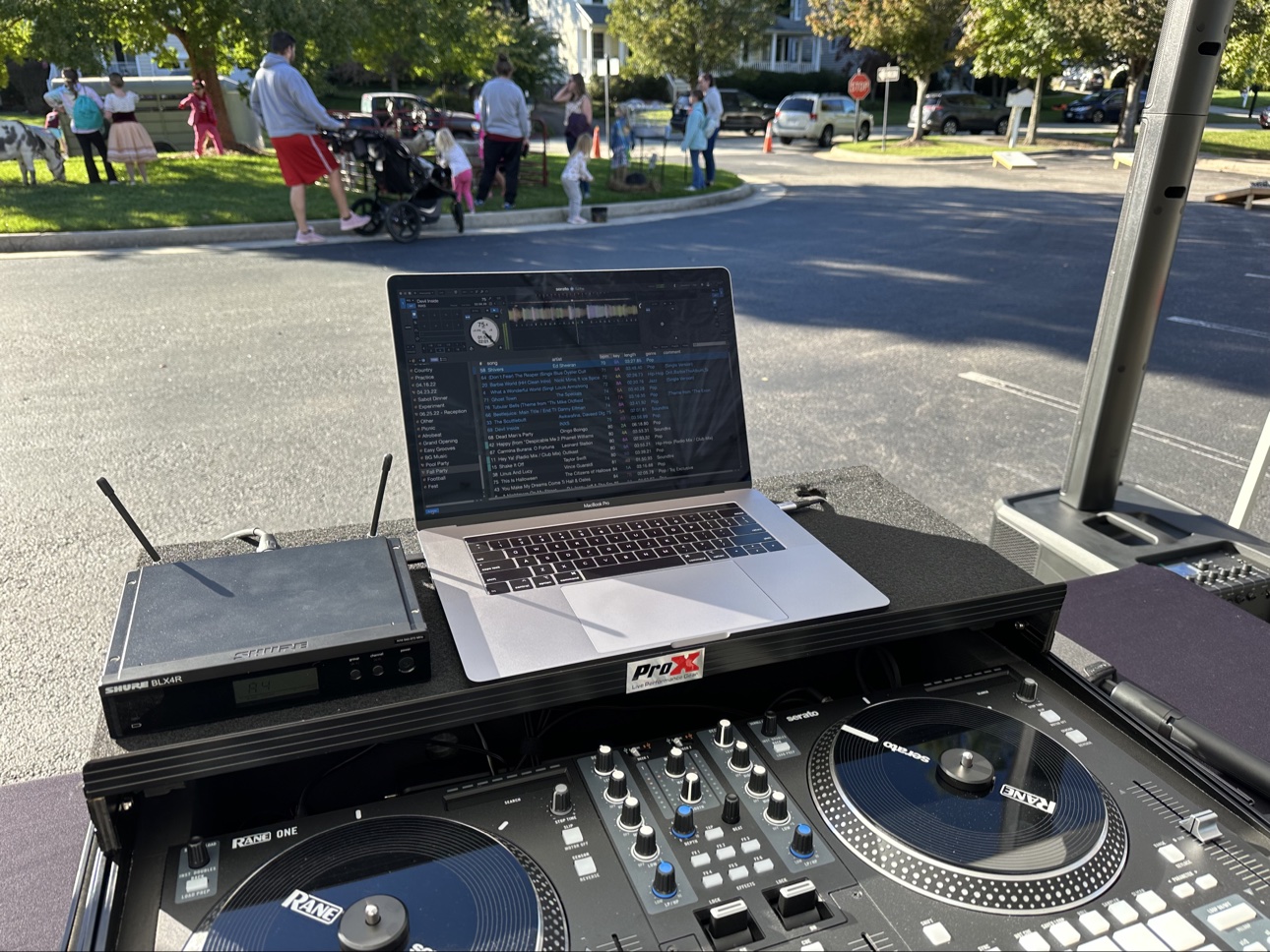 DJ performing at an outdoor neighborhood event