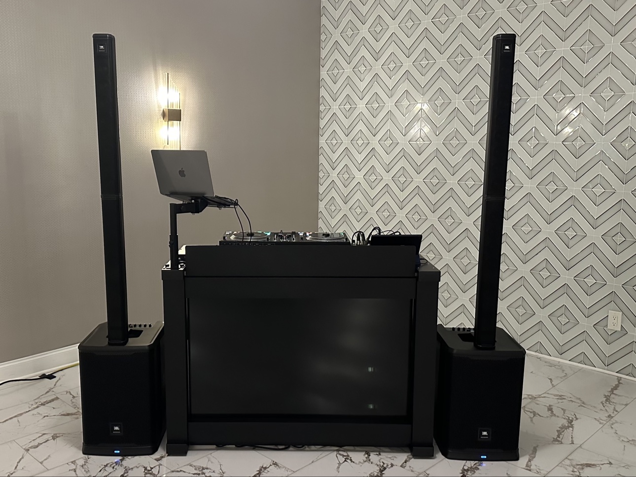 Sleek indoor DJ booth set up for a corporate event