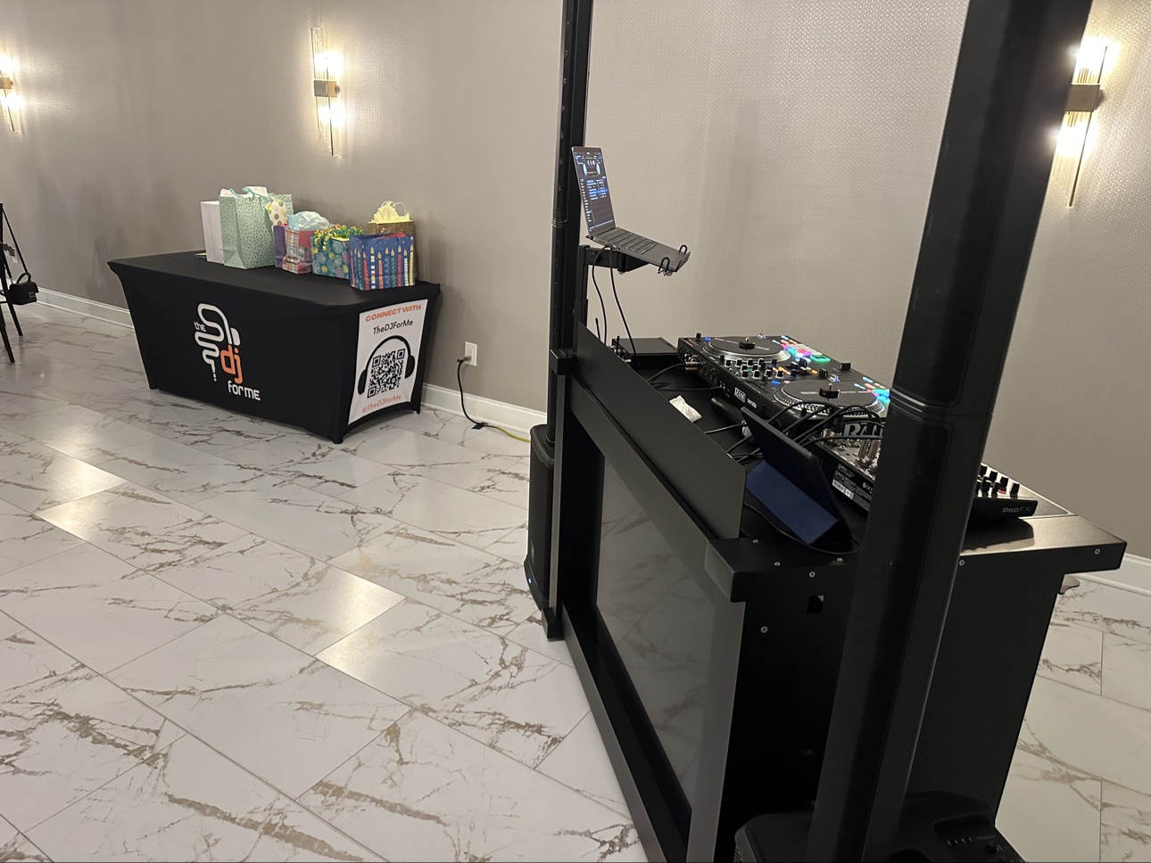 Birthday party setup with gift table beside the branded The DJ For Me booth