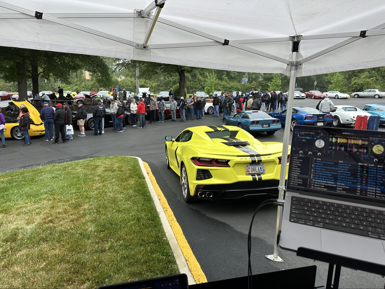 Car club event crowd and Corvettes seen from the DJ booth