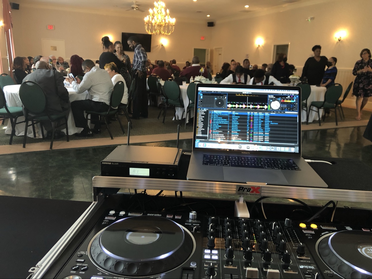 Formal banquet hall with chandelier and DJ setup